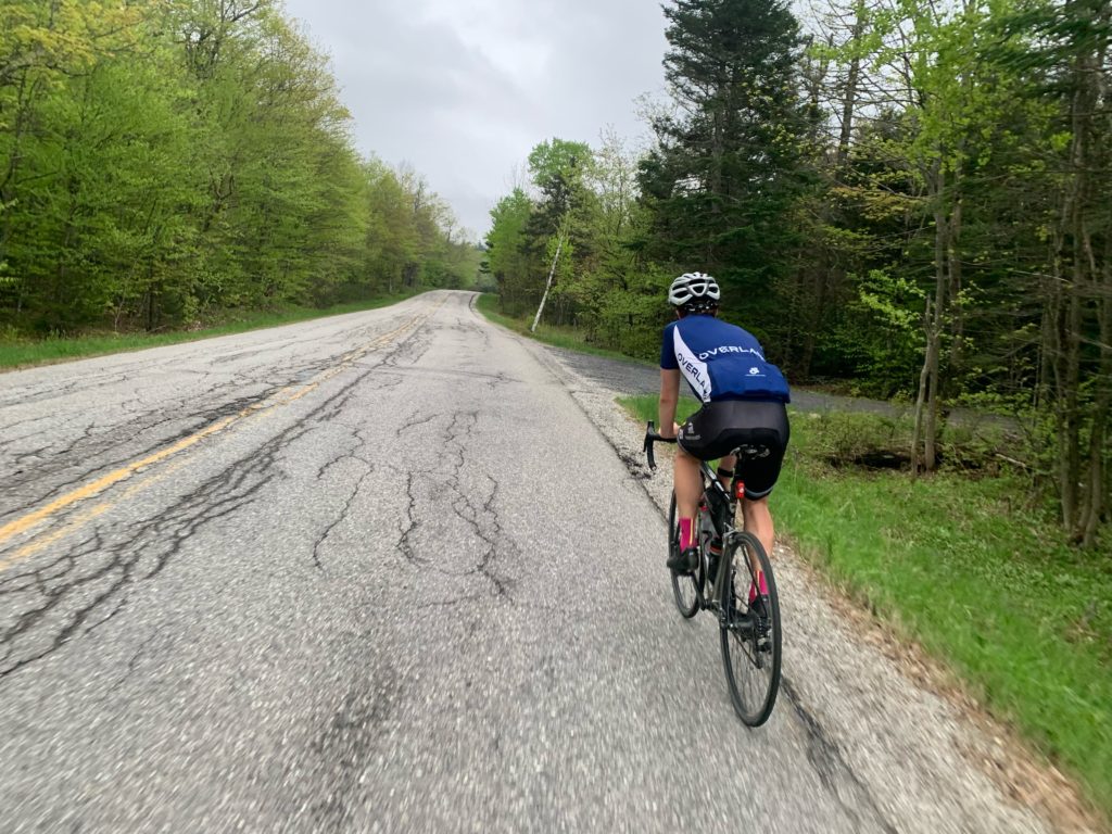 Biking along a forested road in New England