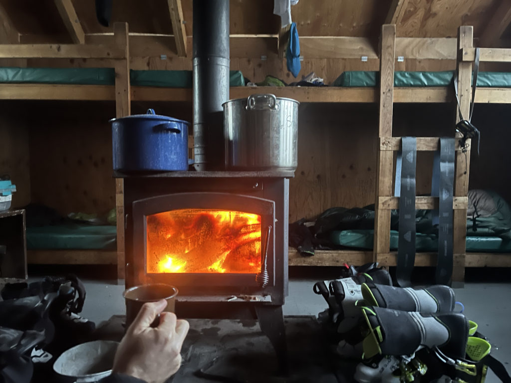 An evening next to the wood stove in a winter hut